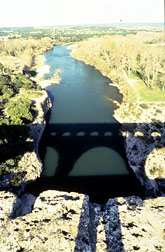 A reflection of Le pont du Gard in the  Gardon river